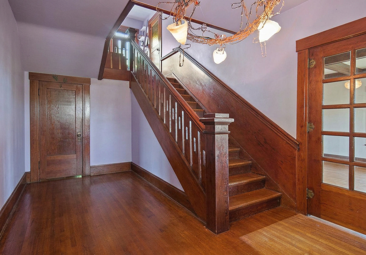 Entry hall and original staircase, shown vacant