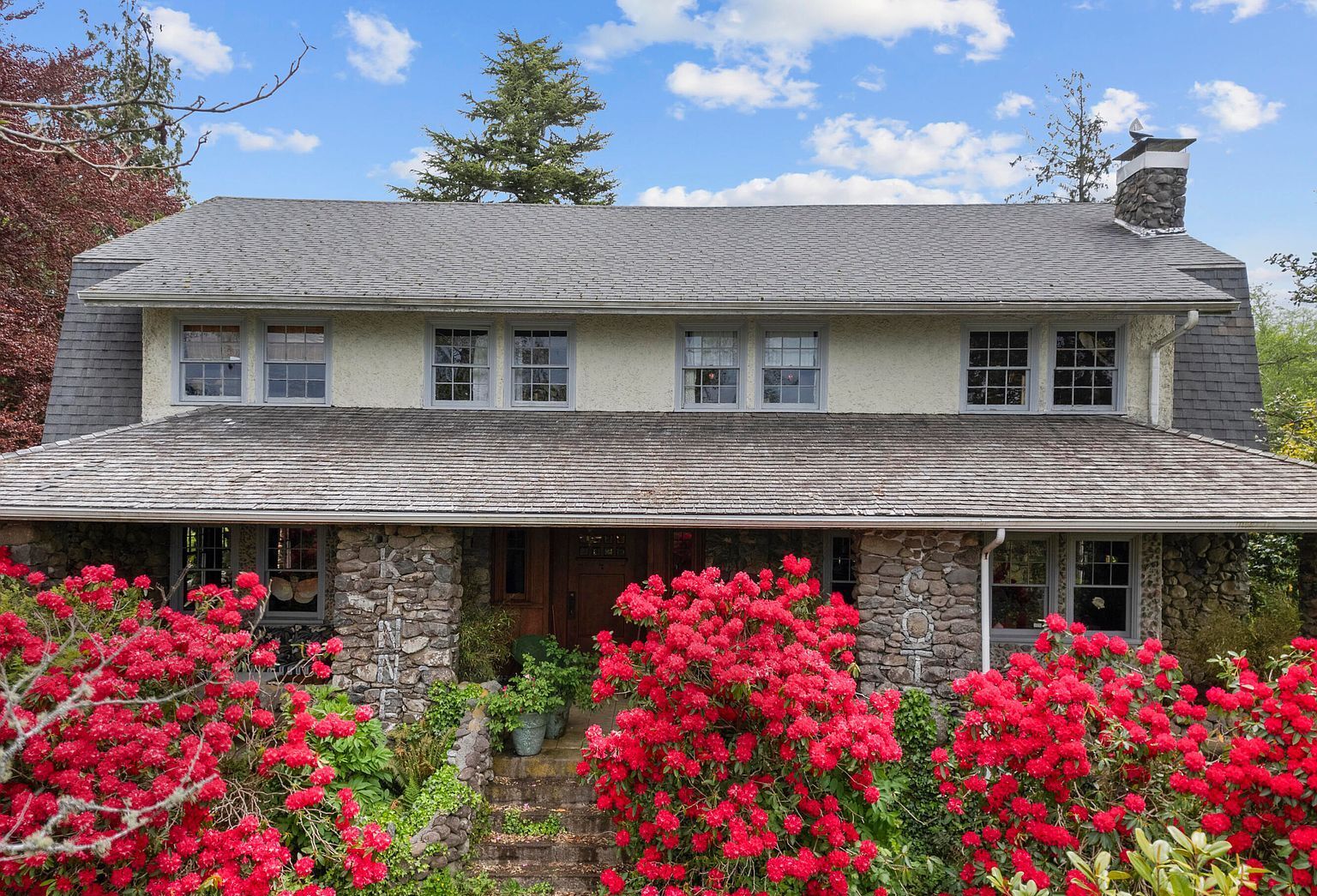 Kinney Cott in spring, heirloom rhododendrons in full bloom along the stone façade